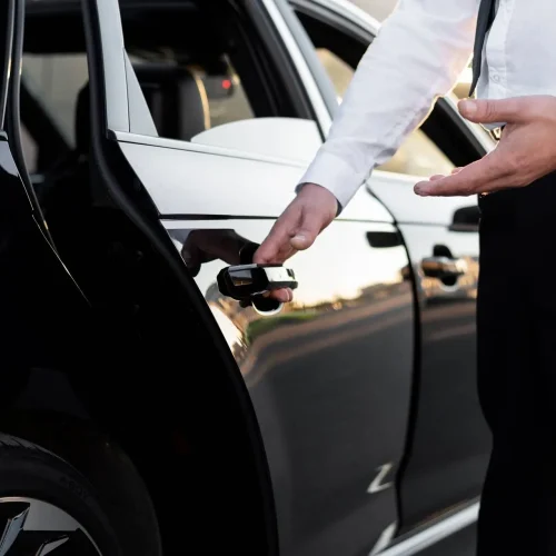 man holding car door handle