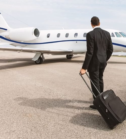 man holding his bag moving towards the airplane